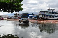 The boats are in the road and the cars are in the river!