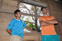 Inside the church, Joaquim and the local church worker talk about the construction