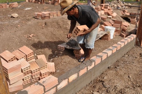 The brick and walls go up